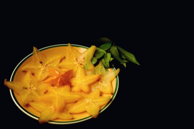 Star fruit or Averrhoa carambola isolated on black background.