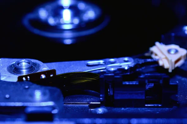 Closeup hard disk detail isolated on blue background.