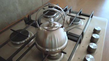 heat iron kettle on a home stove, steam boil water for tea cools down