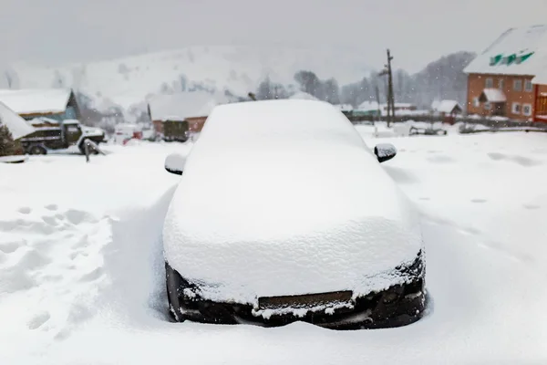 car or auto parking and stuck in snowdrift winter, snowfall cold climate weather in village