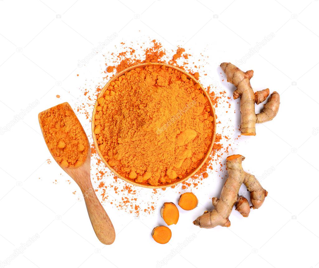 top view of turmeric roots and turmeric powder in wooden bowl is