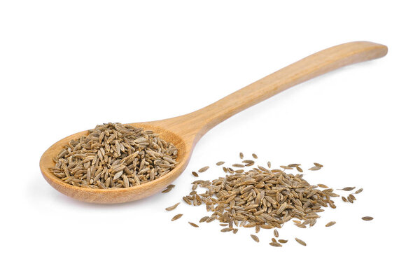 dried cumin seed or caraway in wooden spoon isolated on white ba