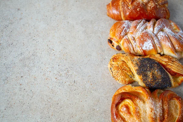 Fresh sweet bun assortment on wooden surface — Stock Photo, Image