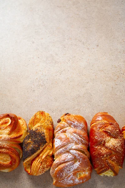 Fresh sweet bun assortment on wooden surface — Stock Photo, Image