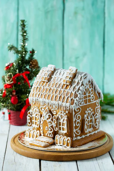 Gingerbread house over turquoise wooden surface — Stock Photo, Image