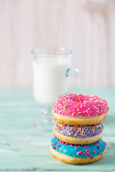 colorful doughnuts and glass of milk