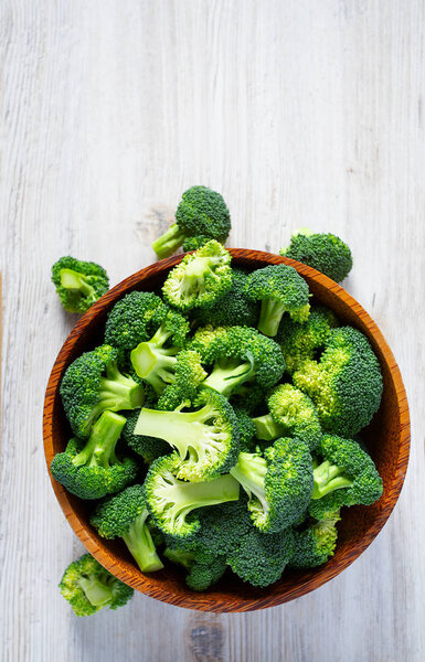 fresh broccoli on wooden surface