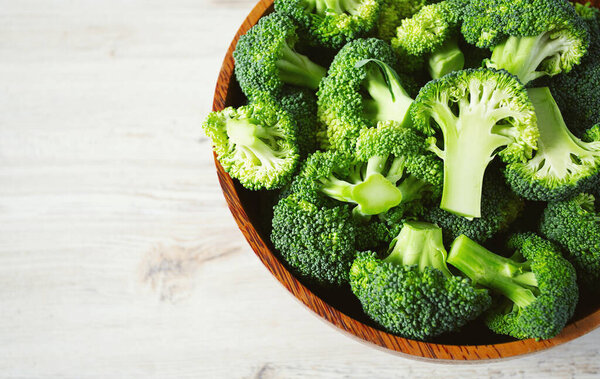 fresh broccoli on wooden surface