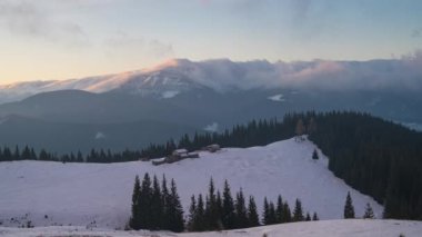 The movement of a dense layer of clouds above the ground. Mountains sprout from the clouds that cover the earth. Time laps 4k
