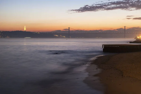 25. april brücke und cristo rei statue in lisbon — Stockfoto