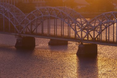 Gün batımında Riga'da demiryolu Köprüsü