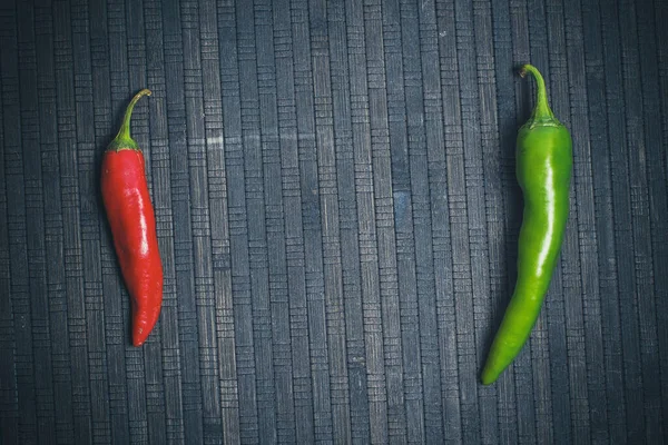 Hot peppers for spicy dishes on a black background