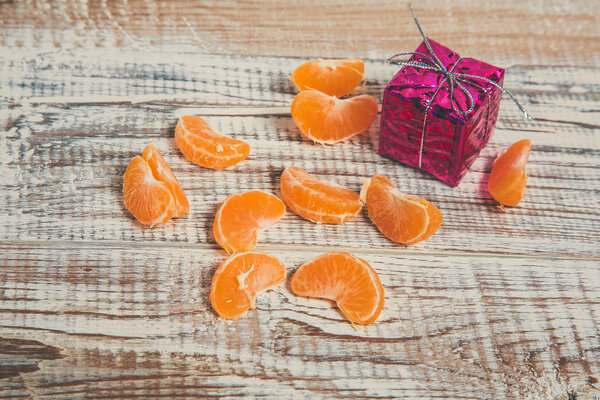 Sweet tangerines for the New Year lie on a white wooden table.