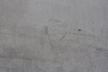 Çizgileri ve çizikleri olan bir inşaat işçisinin gri beton dokusu.