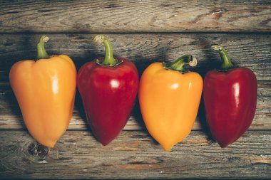 Sweet bell pepper for diet salad on vintage wooden surface