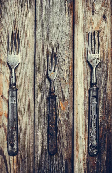 Antique metal rusty fork on a vintage surface