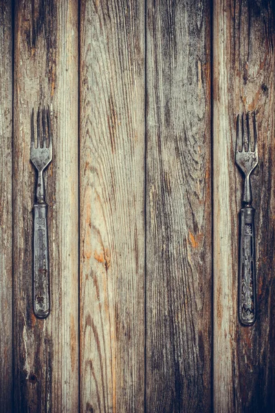 Antique metal rusty fork on a vintage surface