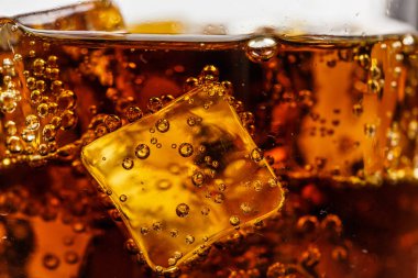 Beyaz arka planda buzlu bardakta siyah soda.