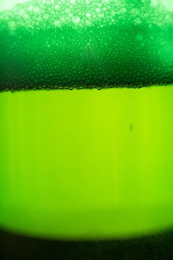 Yeşil şişede köpüklü bira.