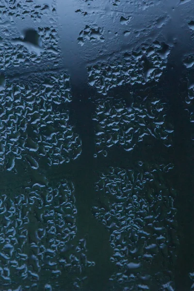 Heavily misted glass windows with water drops