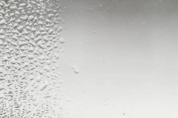 Heavily misted glass windows with water drops