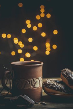 Çikolatalı lezzetli çörekler ve sıcak renkli bir fincan kahve..