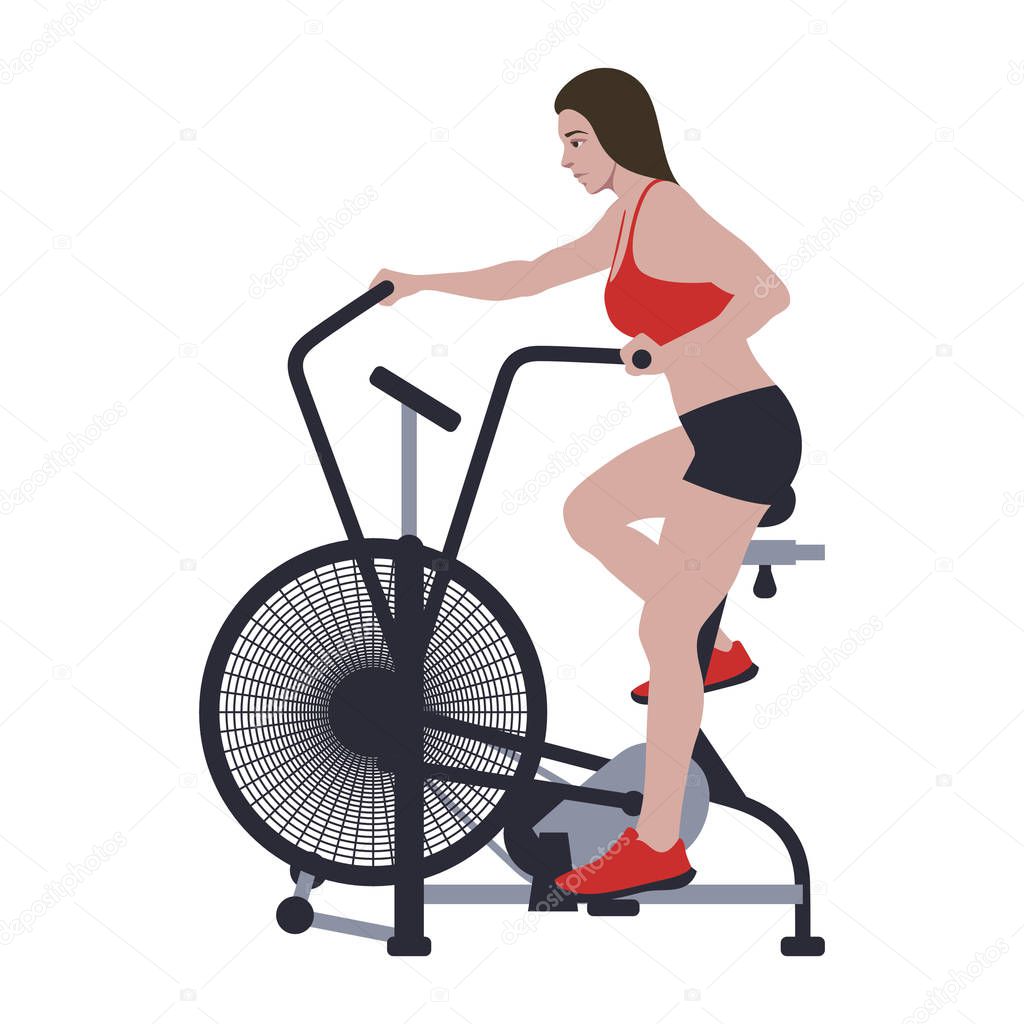 Woman on air bike training CrossFit workout. Healthy life motivation. Assault bike riding sports activity.