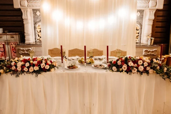 Wedding decoration in a restaurant  - served table with flowers composition