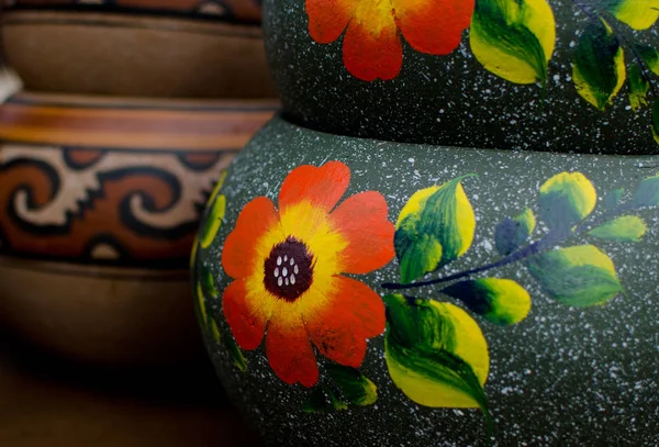 Stack of Mexican ceramic pots, grey background, orange flowers — Stock Photo, Image