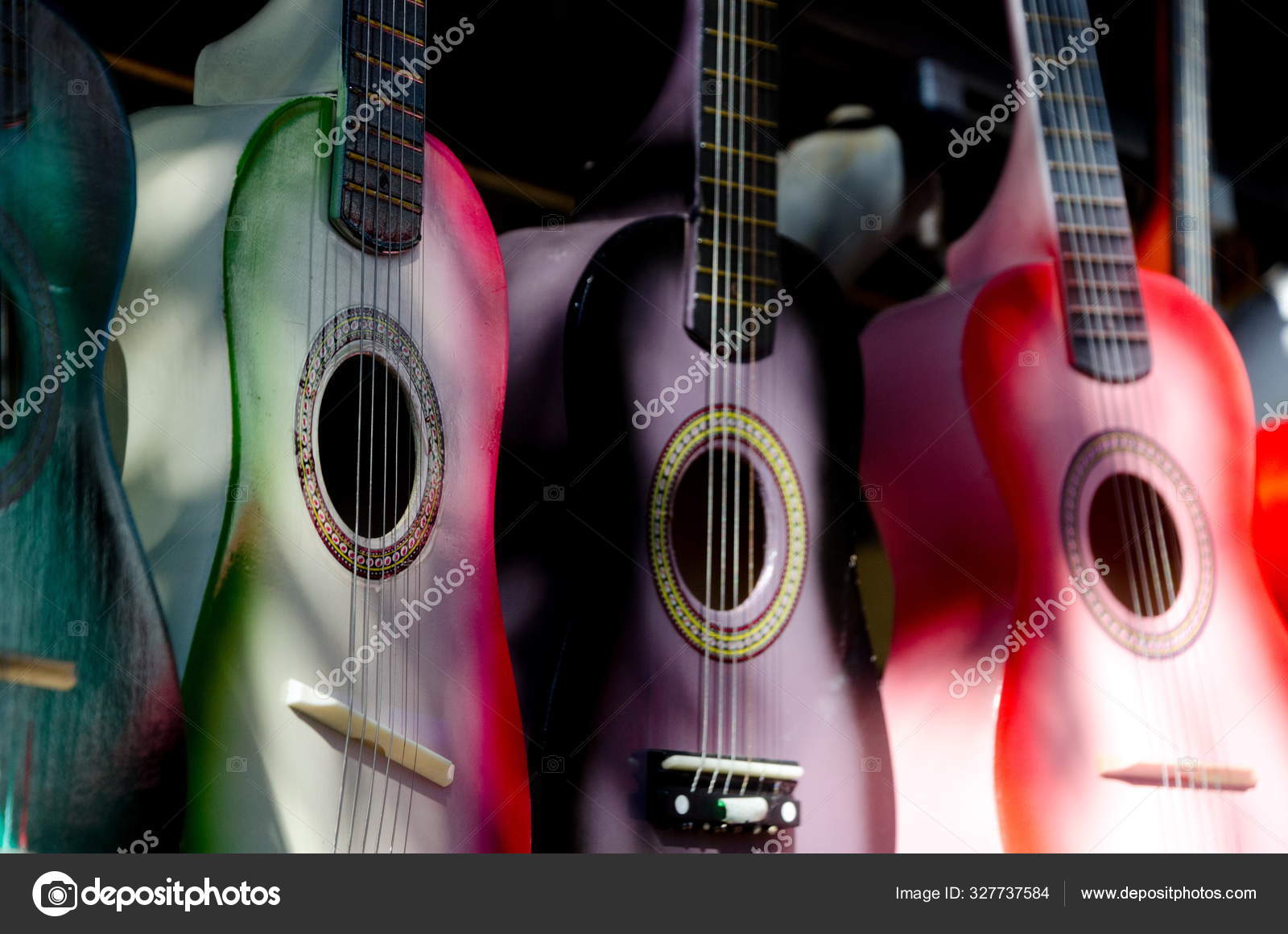 Stand with colorful little wooden guitars at Old Town Market Sa