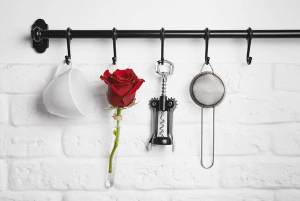 Kitchen utensils, red rose on rank — Stock Photo, Image