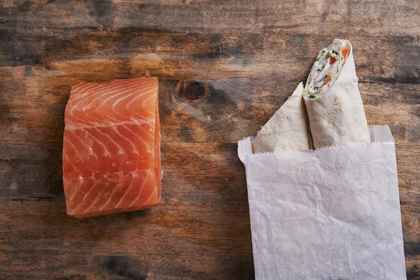 Wrapped sandwich and salmon — Stock Photo, Image