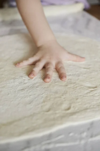 Dough and kid's hand — Stock Photo, Image