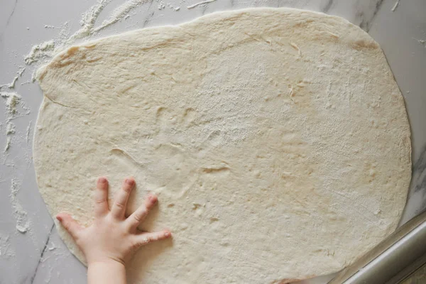 Dough and kid's hand — Stock Photo, Image