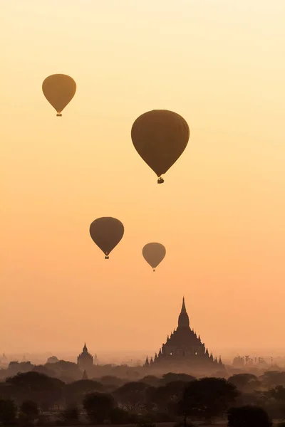 Hot air balloon over misty morning around Temple in Bagan , Myanmar — Stock Photo, Image