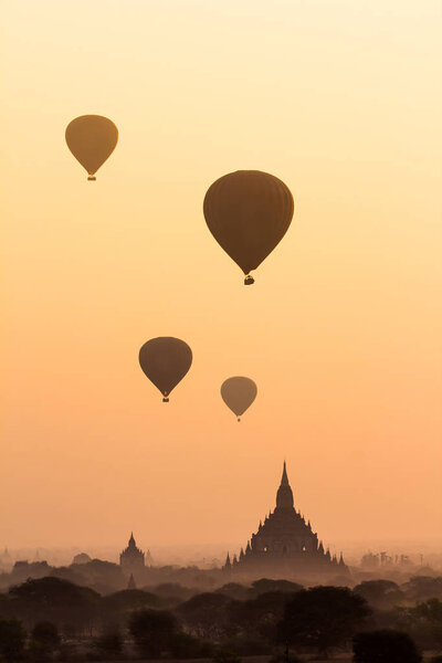 Hot air balloon over misty morning around Temple in Bagan , Myanmar
