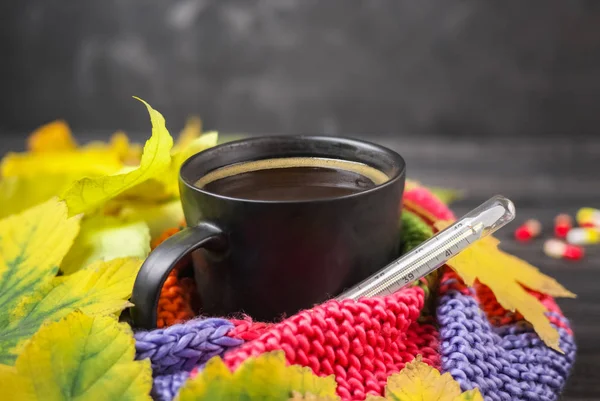 Осінній натюрморт: чашка гарячої кави і термометр, загорнутий — стокове фото