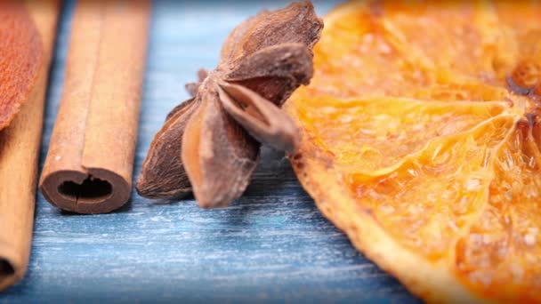 Christmas background: dried oranges, anise stars, cinnamon sticks, sprig of spruce.Close-up. Camera motion from right to left — Stock Video