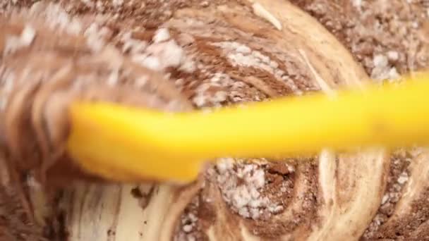 Cucinare un biscotto al cioccolato. Mescolare l'impasto: farina, uova sbattute, cacao in polvere con una spatola di silicone giallo. 4K video. Rallentatore . — Video Stock