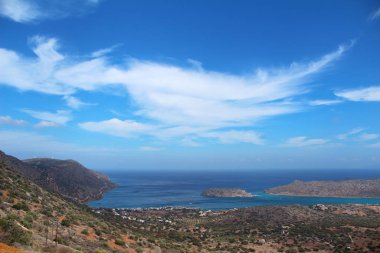 The sea coast, among the mountains of a small town.