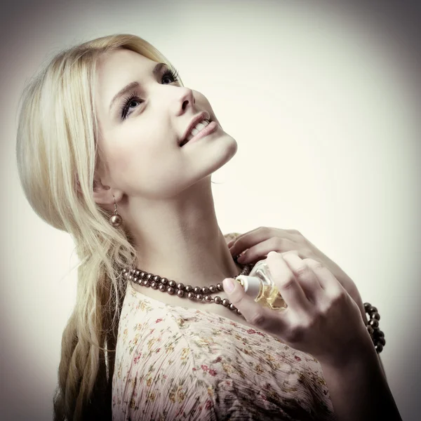 Woman holding bottle of perfume — Stock Photo, Image