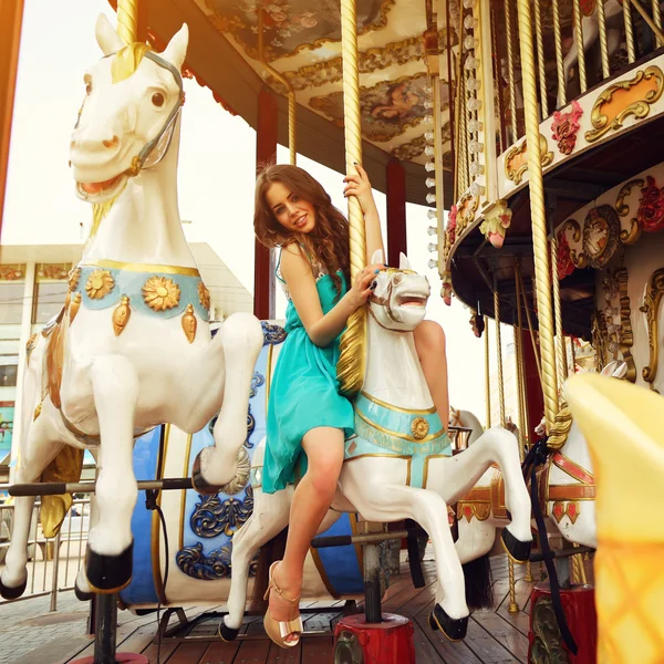 Happy woman on carousel — Stok Foto