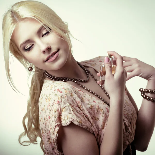 Woman holding perfume — Stock Photo, Image