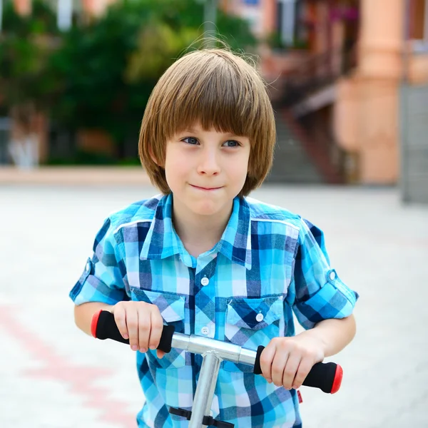 Boy riding scooter — Stock Photo, Image