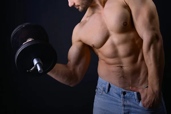 Strong man with dumbbells — Stock Photo, Image