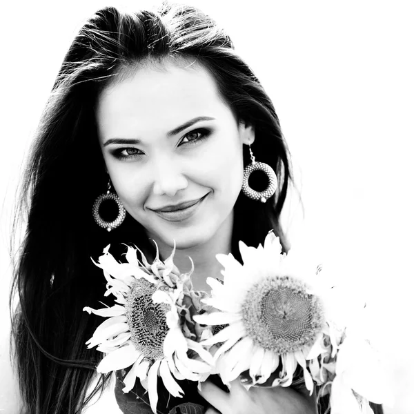 Beautiful woman holding sunflowers — Stock Photo, Image