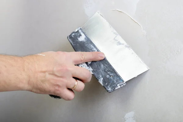 Repairman works with plasterboard Stock Photo