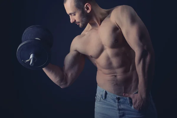 Strong man with dumbbells — Stock Photo, Image