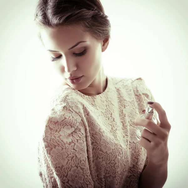 Beautiful Lady holding perfume — Stock Photo, Image