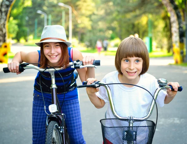 Children with bike in park — Stock Photo, Image